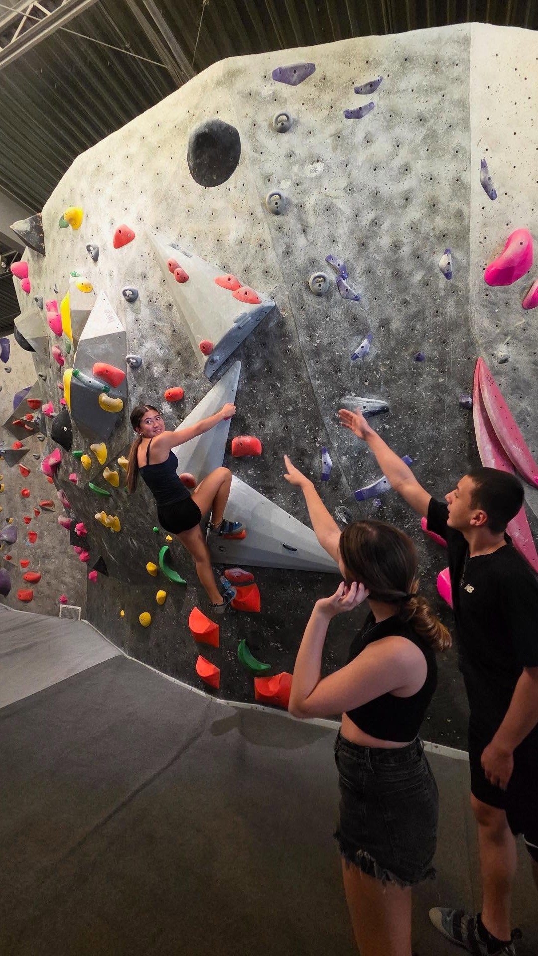 Student enjoying an indoor wall climbing activity